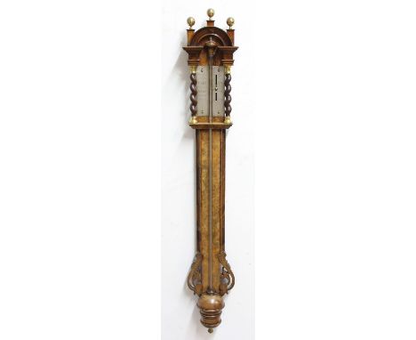 VICTORIAN STYLE WALNUT BAROMETER, with an arched pediment, silvered gauge flanked by barleytwists, moulded trunk with pierced