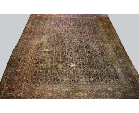 FERAGHAN CARPET OF UNUSUAL SIZE,  West Iran, late 19th century, the deep indigo Herati field enclosed by madder borders of tu