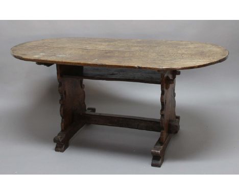 OAK REFECTORY DINING TABLE, possibly late 18th century, the oval top with iron cleating on a trestle base with shelf and stre