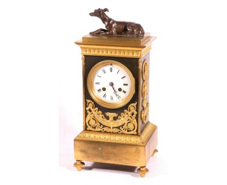 Late 19th century French ormulu mounted clock, surmounted by a recumbent greyhound, Roman enamel dial, the unmarked movement 