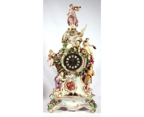Early 19th Century Meissen gilt floral porcelain mantel clock, surmounted by a Goddess playing a horn, modelled with crowned 