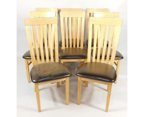 A set of eight light oak lath high back single dining chairs, with over stuffed leather seats raised on tapering, square legs