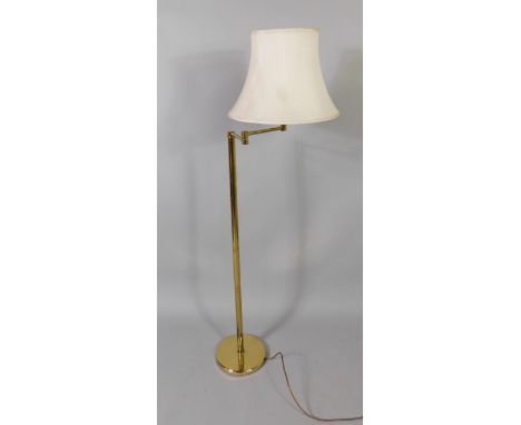 A brass angular stand and lamp, 145cm high and a mesh fire guard, (2).