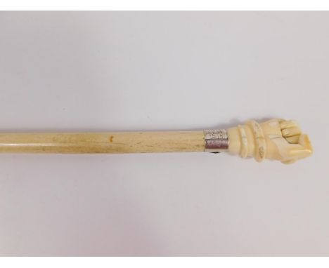 An early 19thC marine ivory and whalebone walking stick, with a serpent enveloped clenched fist handle above a tapering shaft