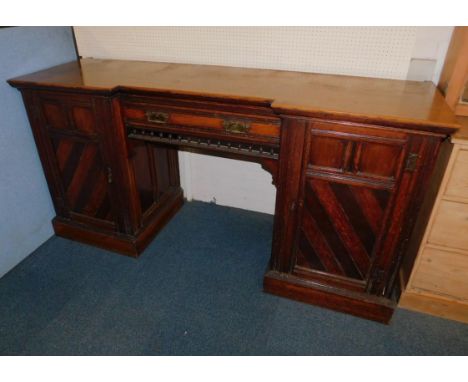 A Victorian oak break front sideboard, with a single frieze drawer flanked by a pair of diagonal banded panel doors, raised o