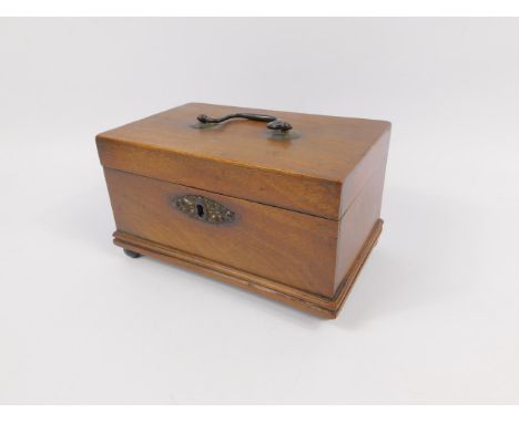 A George III mahogany three division tea caddy, with brass carry handle, raised on four ball feet, 21cm x 13cm x 12cm.