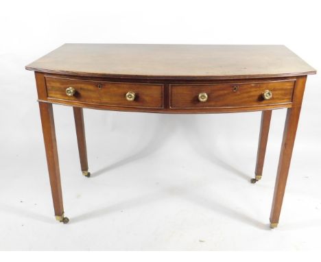 A George III mahogany bow fronted side table, the top with a reeded edge, above two frieze drawers, on square tapering legs w