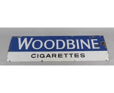 A Woodbine Cigarettes blue and white rectangular enamel advertising sign, 43cm x 153cm.