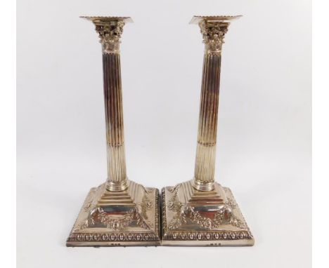 A pair of George III silver candlesticks, probably by Richard Rugg the First, each formed as corinthian columns with square d