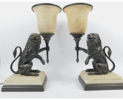 A pair of Regency style table lamps, in the form of cast bronze lions rampant, 45cm high