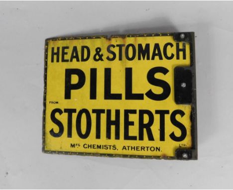 A Stotherts Ltd black and yellow rectangular enamel advertising sign, Head & Stomach Pills, Mfg Chemists, Atherton, 30cm x 37