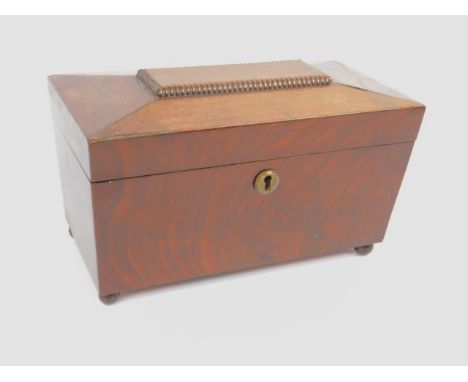 A Regency mahogany sarcophagus tea caddy, with a mixing bowl recess flanked by two tea containers, raised on ball feet, 28cm 