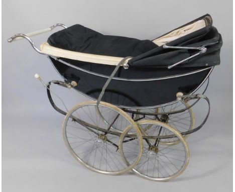 A Robotham Marmet carriage built pram, black with white trim, 138cm long.