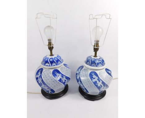 A pair of modern Chinese blue and white pottery table lamp vases, each bombe circular body decorated with stripes of geometri