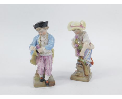 A pair of 19thC Continental figures, of a boy and girl, each dressed in finery, he in pink striped trousers, she holding flow