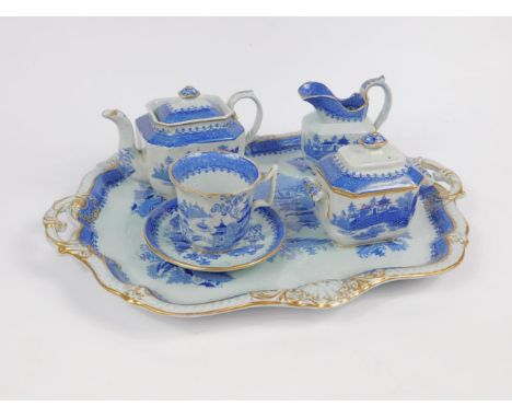 A Minton mid 19thC blue and white solitaire set, decorated with chinoiserie landscapes, comprising teapot, sucrier, cream jug