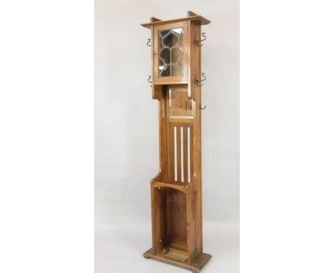 A Victorian Arts & Crafts oak coat and stick stand, with a glazed top and slatted back, 214cm high.