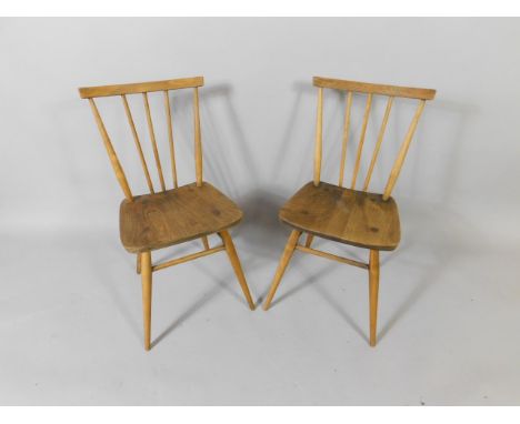 A pair of Ercol 1960's oak and elm 391 kitchen chairs.