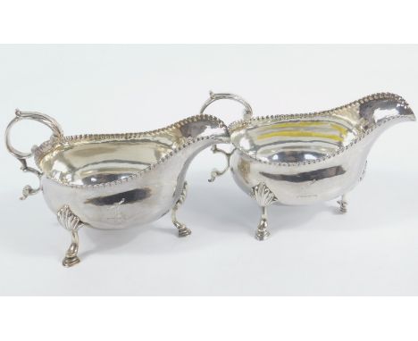 A pair of George III silver sauce boats, by William Sumner the first, each with flying acanthus leaf capped 'S' scroll handle