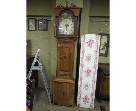 An early 19th Century rustic longcase clock in oak case, painted arched dial decorated rural scenes and sea shells, the cream