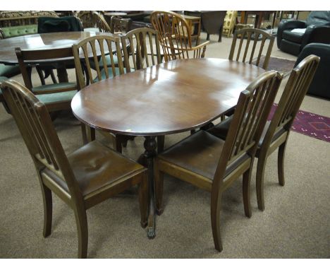 A set of six mahogany ladder back dining chairs with curved cresting rails, fitted drop-in seats upholstered in brown imitati