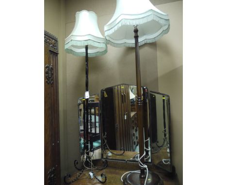 A wrought iron standard lamp and shade; and a wooden standard lamp and shade.