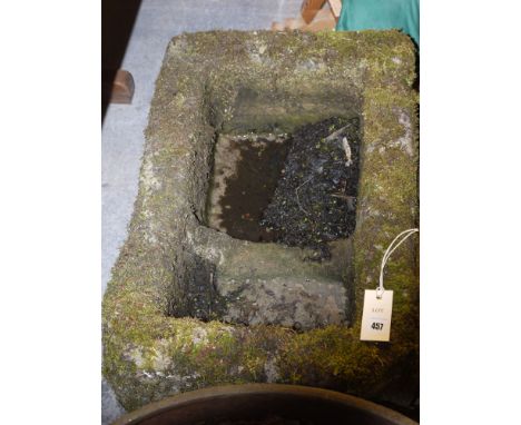 A medium sized rectangular stone trough.