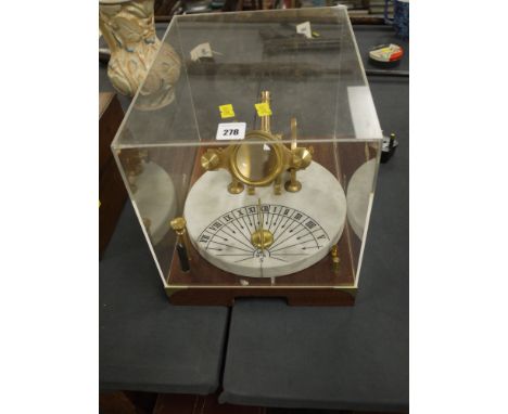 A modern model of a Noon canon with sundial, a perspex case and instruction booklet.