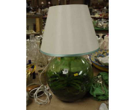  A large green glass container made into a lamp; complete with a plant inside.