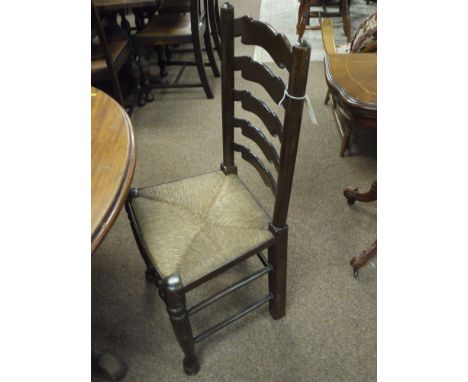 A set of three modern rustic style ladder back dining chairs with ropework seats, raised on turned front legs joined by stret