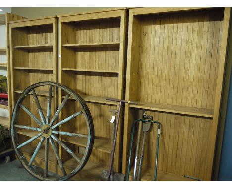 Three stained open pine shelf units with adjustable shelving.