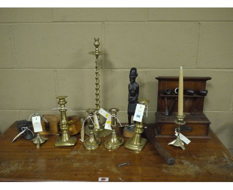 Three pairs of brass candlesticks, various; a single spiral twist brass candlestick; a pipe rack with four pipes; a carved wo