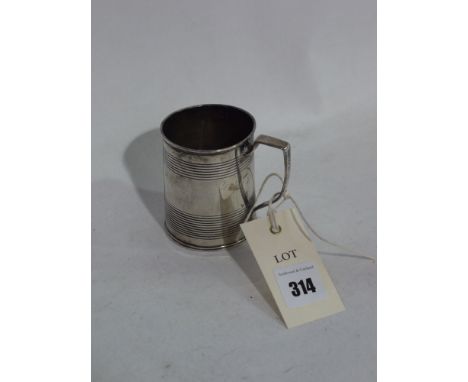 A George III silver christening tankard, by *R., London 1816, of tapering form with shaped handle and two fluted bands, engra