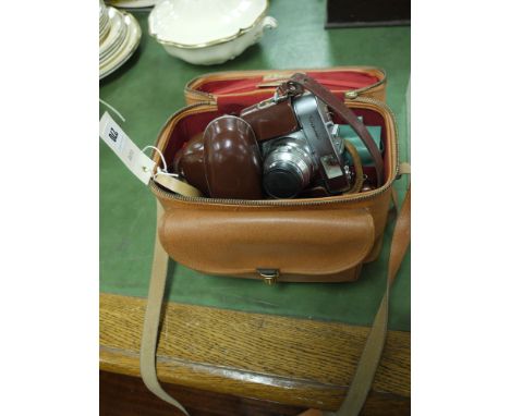 A Voigtlander Vito model B camera in leather case; and a carrying case with accessories.