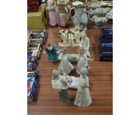 A collection of eight Spanish ware Lladro style ornaments, various; a Doulton figurine 'Rhapsody'; and a pair of ware book en