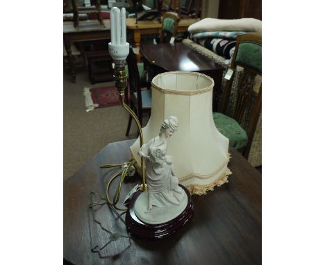 A Capodimonte figure table lamp and shade together with a reproduction mahogany CD storage unit.
