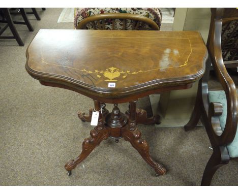 A reproduction inlaid mahogany turnover top card table with baize lined interior, raised on a four column base on four ornate