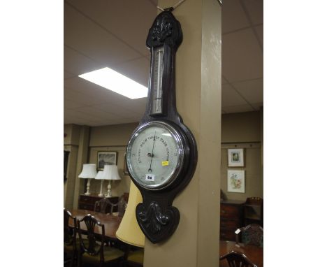 An aneroid barometer and thermometer in dark stained and carved oak banjo pattern mount together with: a Minolta SR7 303 came