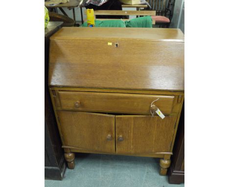 A mid 20th Century light stained oak bureau.