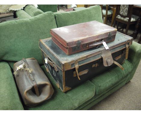 A small leather suitcase inscribed initials 'W.D.'; together with a large leather bound trunk; and a leather Gladstone bag (m