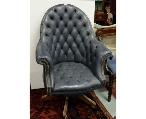 Mid-20thC Swivel Office Armchair, covered with blue leather, button features to seat and back, on pedestal, 32”w x 48”h