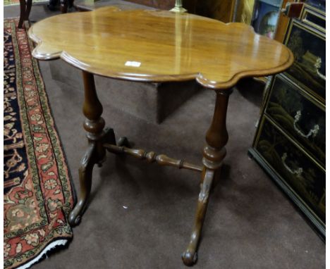 19thC Mahogany Occasional/Lamp Table, the serpentine shaped top on turned legs, with stretcher, scrolled feet, 34”w x 22”d x 