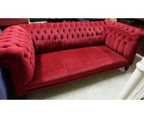 Victorian Roll Top Chesterfield Sofa, covered with button detailed red velvet, 77” wide, on turned legs 