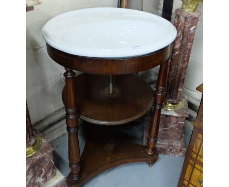 Circular ceramic sink, with leaf impressed soap trays, in a mahogany base, with 3 turned leg supports, on castors, 2ft dia x 