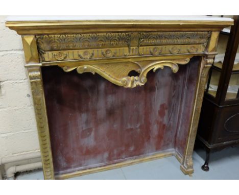 Mid-20thC French Carved and Gilded Fire Surround (not for wood), the rimmed white marble top over a decorative frieze with sw