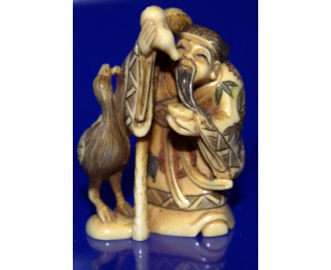 Meiji Period Stained Ivory Netsuke Depicting A Wise Man Feeding A Stork, Signed To Base 