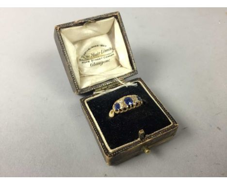EIGHTEEN CARAT GOLD RING,set with three sapphires and diamond chipsThe ring setting is 15.2mm x 7.4mm. The ring size is Q. We