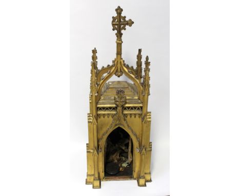 A 19th century wooden gilt tabernacle in the style of a Gothic tower, two arched doors opening with remnants of silk satin ec