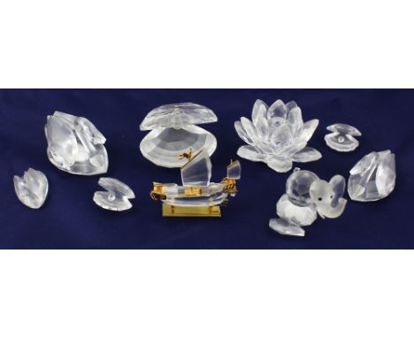 A small collection of Swarovski lead crystal to include a graduated set of three swans, one large and two small pearl bearing