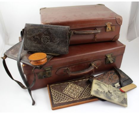 Two vintage brown leather suitcases, one marked 'Genuine Vulcan Fibre Pioneer British Made', the other marked 'Guaranteed Raw